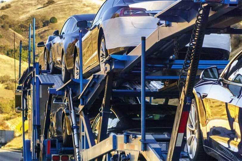 An open car transport trailer. Shipping a vehicle with National Transport Services is safe and easy.