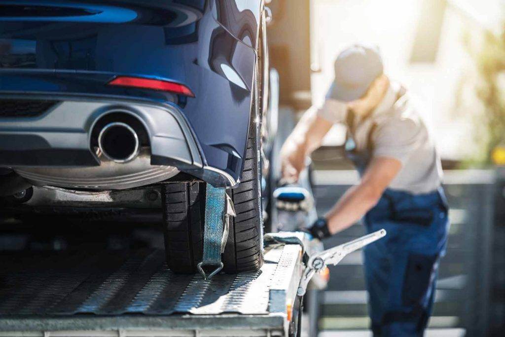A car being loaded up for shipping: How Much Does It Cost to Ship a Car Across the Country?