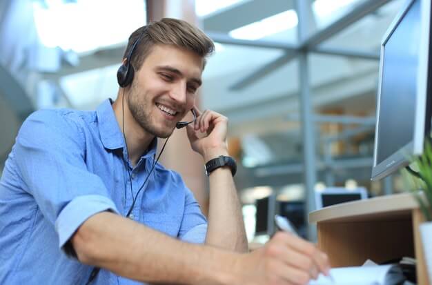 Customer service representative smiling on the phone