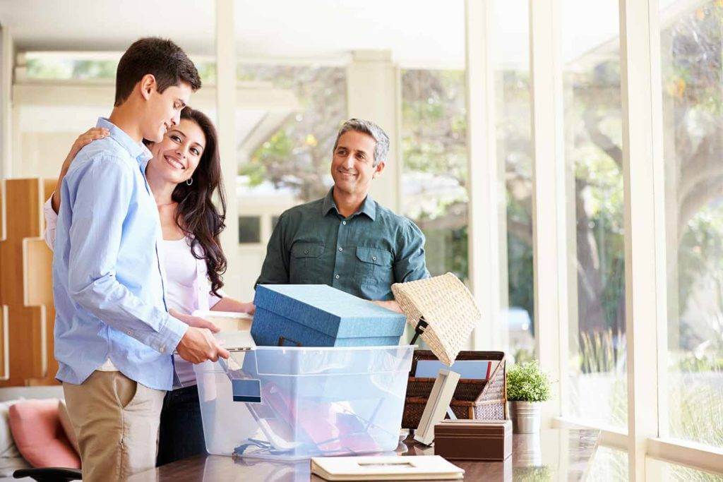 Parents helping teenager pack for college.