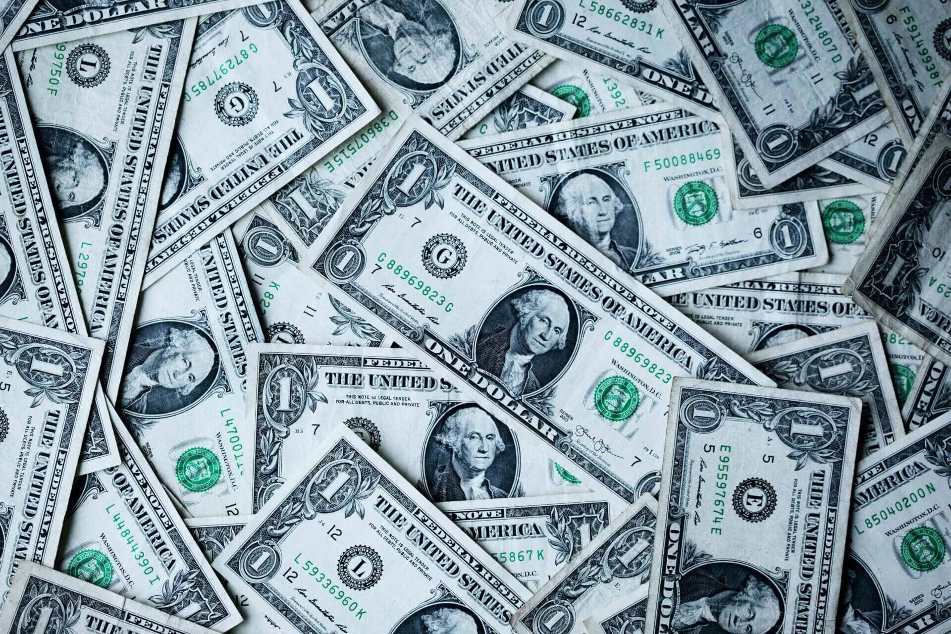 multiple single-dollar bills lay flat. What is the average cost to ship cars?