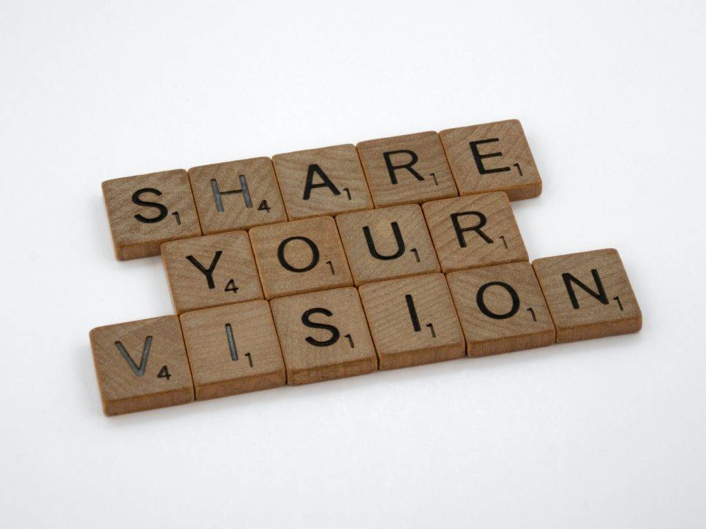 Board game letter blocks spelling out the words "share your vision". dealership car delivery