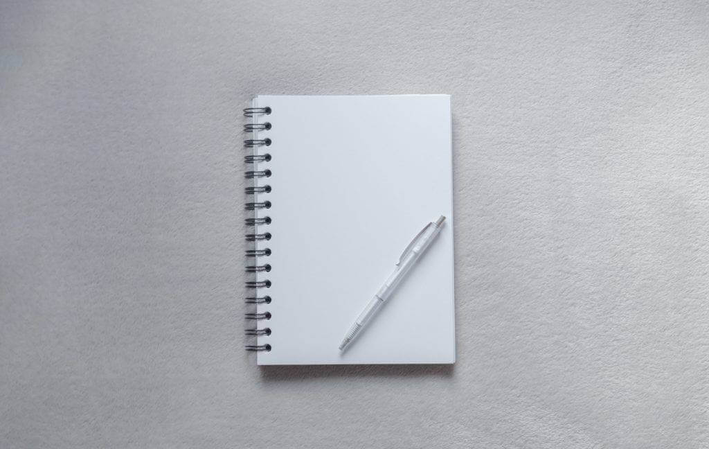 A blank note pad and pen. car shipping cost.