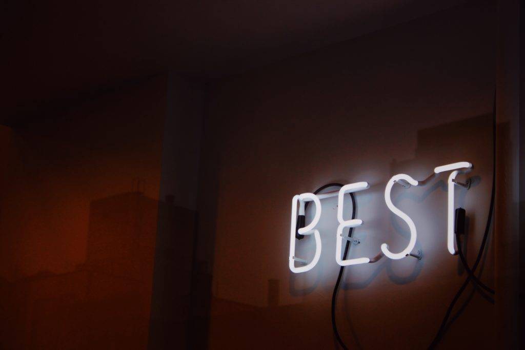 The word "best" in neon lights. Best auto transport companies.