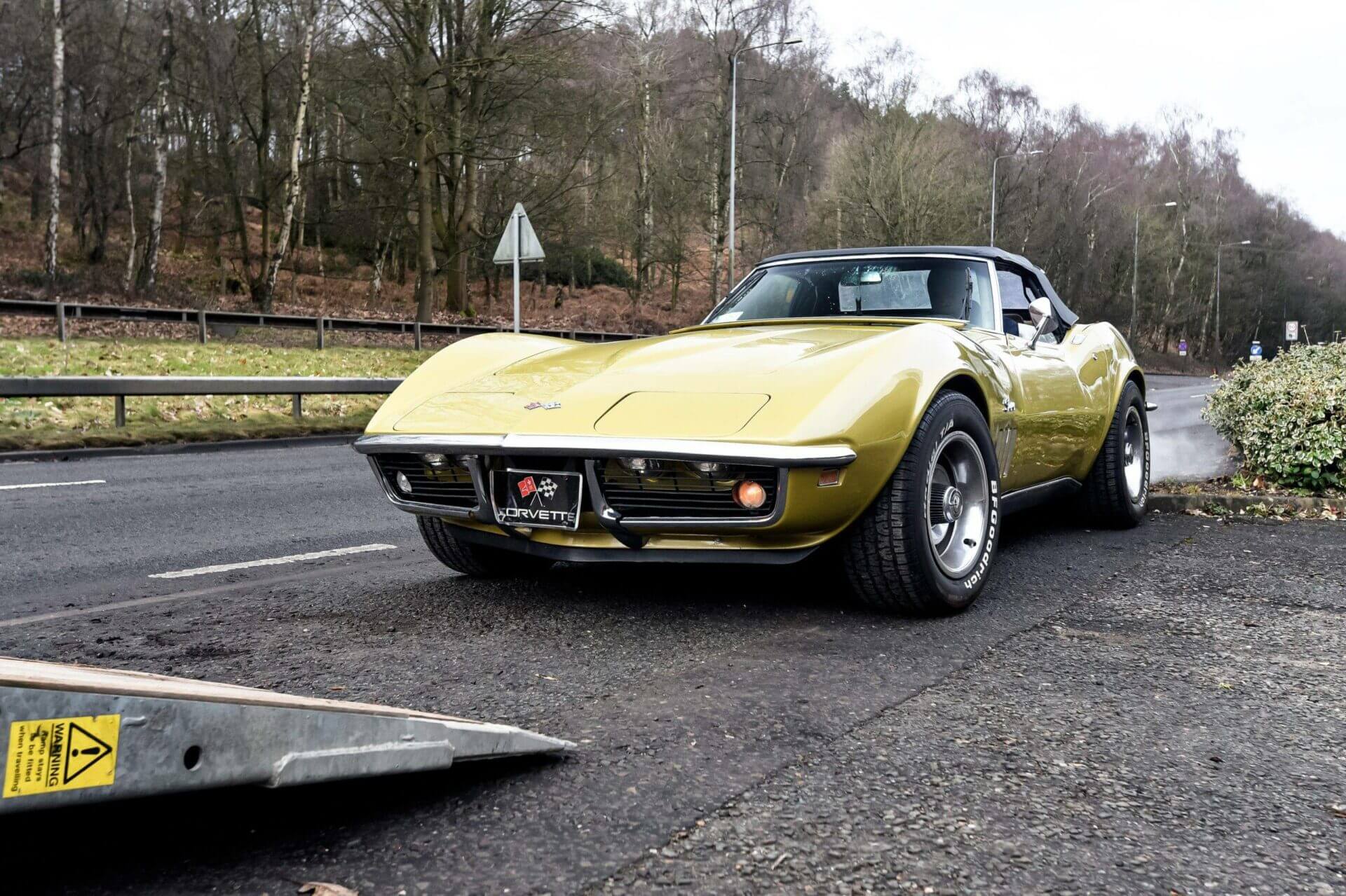 A classic Stingray Chevrolet Corvette is getting loaded onto a car trailer. Looking for "car shipping near me"? Contact us today for a free auto transport quote.