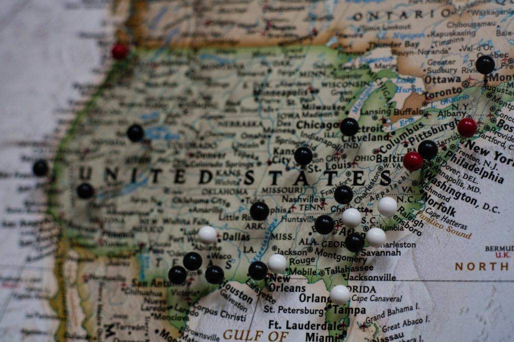 A map of the United States with black, white, and red pins. Want to ship a car to another state? National Transport Services are the experts in shipping a car to another state.