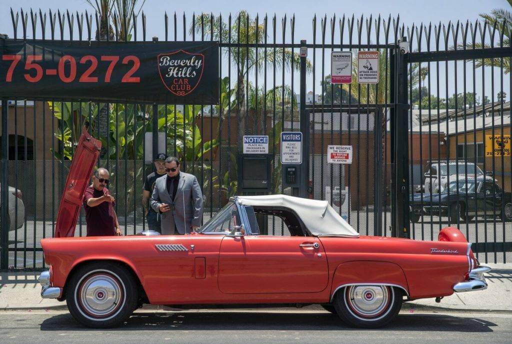 1950s Ford Thunderbird parked in front of Beverly Hills Car Club's building. They sell American vintage autos and American classic cars.