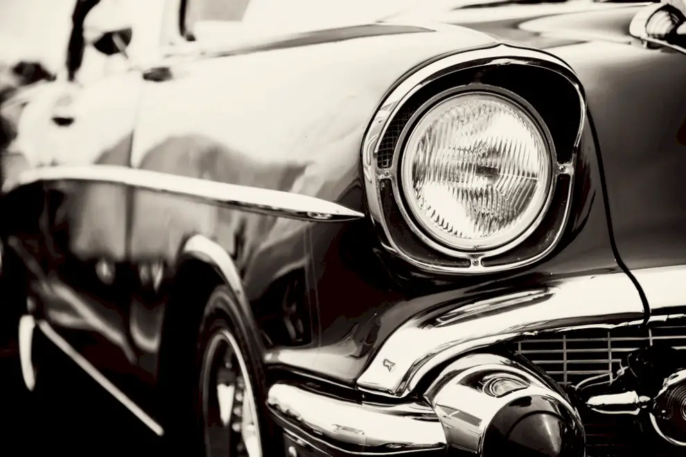 Classic car headlights close up. Who Is The Cheapest Car Shipping Companies? National Transport Services offers the best service and competitive rates.