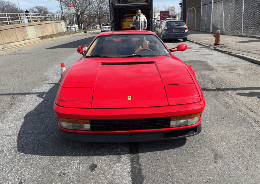 A red 1987 Ferrari Testarossa was just unloaded from an enclosed car transport trailer. We can move any car across the country, new or vintage, exotic car, or daily drivers. When it comes to safety and the feeling of mental peace, enclosed car shipping is the no-brainer option for auto transport.