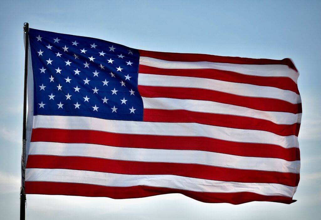 The American Flag is raised high on a sunny day and is blowing in the wind. Look for a car transport company that offers car shipping discounts on their website. National Transport Services is based in San Antonio, TX, a military city. As you know, we specialize in military vehicle shipping.