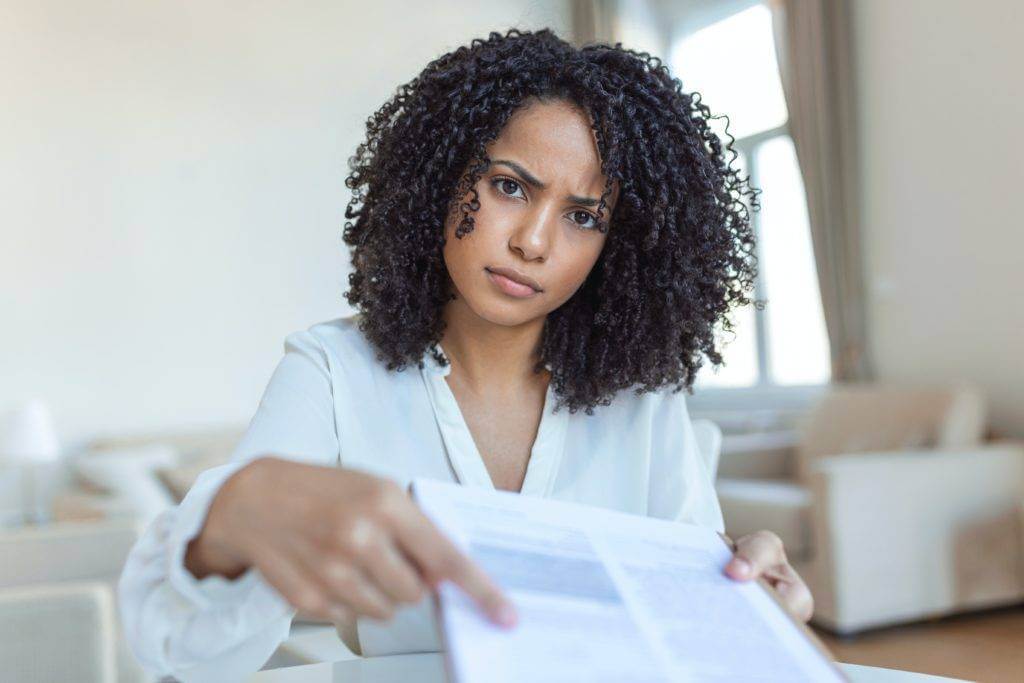 A woman is pointing at a contract.