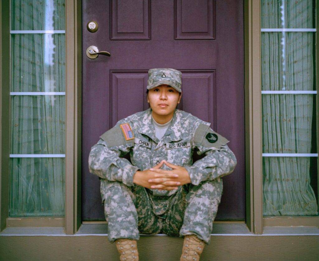 A woman soldier is sitting in front of the door to her home. In the auto transport industry, there are only a few companies offering car shipping military discounts.