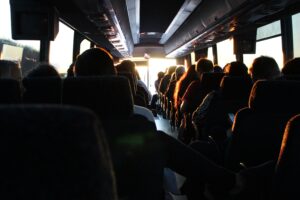 People are sitting in a travel bus.