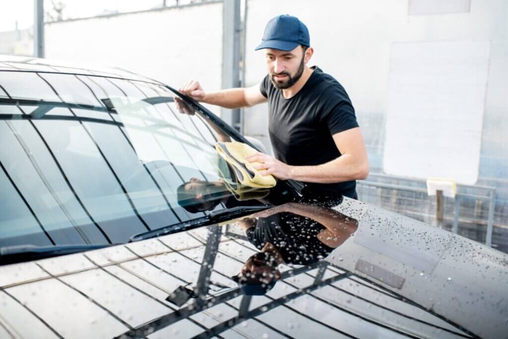 A man is cleaning his car.